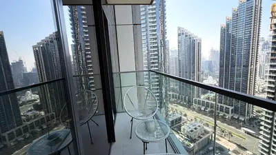 two empty chairs on a balcony in a city at Boulevard Sea View Luxury 1 BR Next Dubai Mall in Dubai