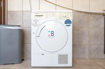 a washing machine sitting next to a wall at StayShort - Majestic 4BR in Dubai Marina - Sleeps 8 in Dubai