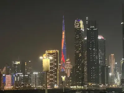 a nighttime view of a large city at night at Burj Khalifa View Ideal for Families in Dubai