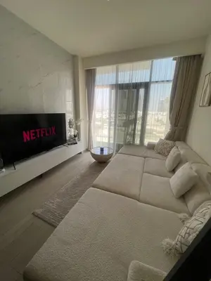 a living room with a large bed and a tv at Burj Khalifa View Ideal for Families in Dubai