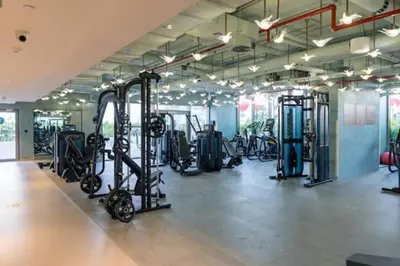 a gym with several treadmills and elliptical machines at Vogue Downtown Mag 318 near Burj Khalifa and Dubai Mall, Studio Apartment with Balcony, Canal and City Skyline View, Access to all Amenities in Dubai
