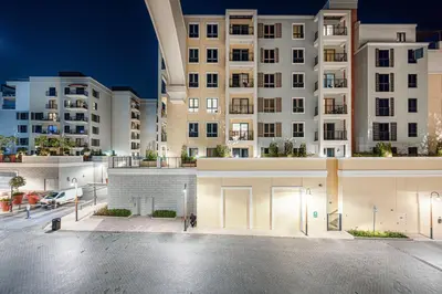 an empty parking lot in front of a large building at Coastal Hideaway in La Mer - Beach Access and Burj View in Dubai