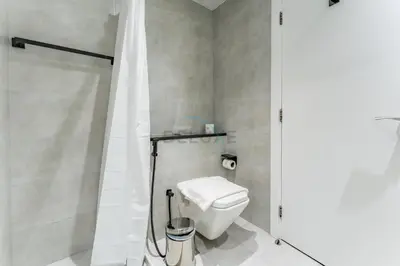 a bathroom with a white toilet and a shower at Charming Studio, Easy Access to Beach - Botanica Tower, Dubai Marina by Deluxe Holiday Homes in Dubai