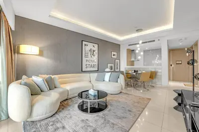 a living room with a white couch and a table at Burj Khalifa View - Luxurious 1BHK in Business Bay in Dubai