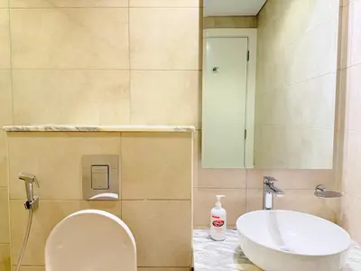 a bathroom with a toilet and a sink at Cozy 2BHK - Sea View in Dubai