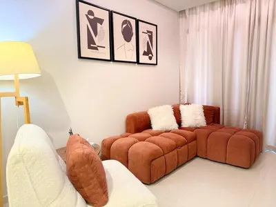 a living room with a couch and two chairs at Cozy 2BHK - Sea View in Dubai