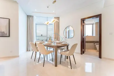 a dining room with a table and chairs and a mirror at Burj Khalifa View, Easy Access to Dubai Mall and Burj Khalifa - Imperial Avenue, Downtown Dubai by Deluxe Holiday Homes in Dubai