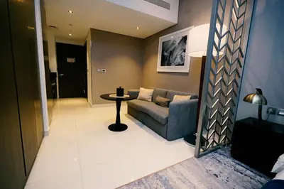 a living room with a couch and a table at Luxury Studio at PRIVE by DAMAC - Canal Views in Dubai