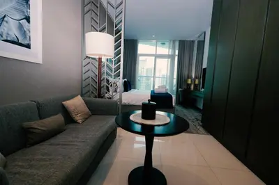 a living room with a couch and a table at Luxury Studio at PRIVE by DAMAC - Canal Views in Dubai