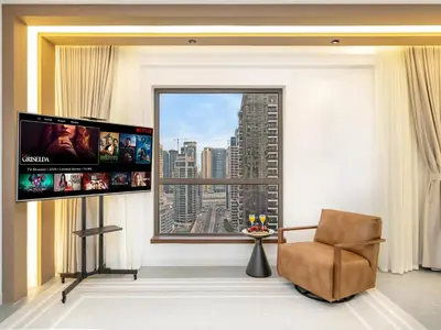 a living room with a large window and a chair at 4 BHK JBR BEACHFRONT# Next to Dubai Eye# Marina View in Dubai