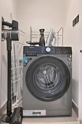 a washing machine sitting in a room at Socio Tower Apt - Parking, Balcony&Pool - by Rentujemy in Dubai