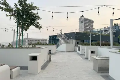 a rooftop of a building with white walls and lights at Cosy Sobha Hartland Apt - Pool&Gym - Near Downtown in Dubai
