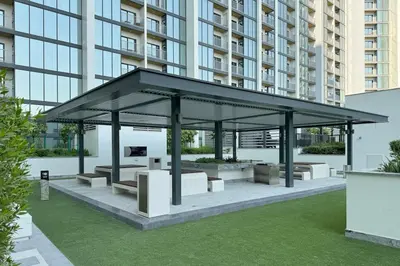 a pavilion in front of a tall building at Cosy Sobha Hartland Apt - Pool&Gym - Near Downtown in Dubai