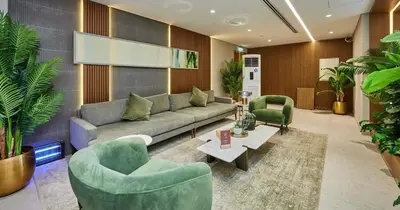 a living room with a couch and two chairs at Luxury Studio in Dubai in Dubai