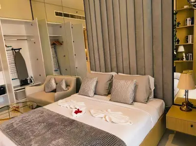 a bedroom with a large bed with white towels on it at Luxury Studio in Dubai in Dubai