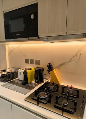 a kitchen with a stove with a toaster and a microwave at Luxury Studio in Dubai in Dubai