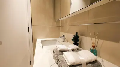 a bathroom with a sink and towels on a counter at Luxury Studio in Dubai in Dubai