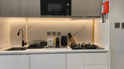 a kitchen with a sink and a stove top oven at Luxury Studio in Dubai in Dubai