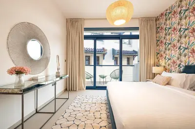 a bedroom with a large bed and a mirror at Palm Jumeirah Luxury Villa 4BR Private BeachAccess in Dubai