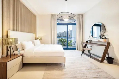 a bedroom with a bed and a desk and a window at Palm Jumeirah Luxury Villa 4BR Private BeachAccess in Dubai