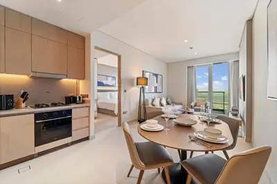 a kitchen and dining room with a table and chairs at Vida Residences Dubai Mall Spacious 1BR Apartment in Dubai