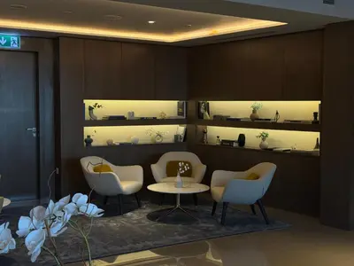 a waiting room with chairs and a table and shelves at Urban Luxury Burj Vista Apartments Direct Burj Khalifa View in Dubai