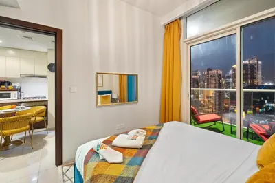 a bedroom with a bed and a large window at Fireworks Burj Khalifa View - One bedroom Apartment in Dubai