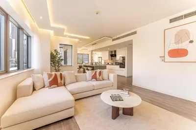 a living room with a couch and a table at HAVN - 3 Bedroom in Downtown, Burj Khalifa View in Dubai