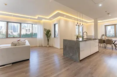 a kitchen and living room with a couch and a table at HAVN - 3 Bedroom in Downtown, Burj Khalifa View in Dubai