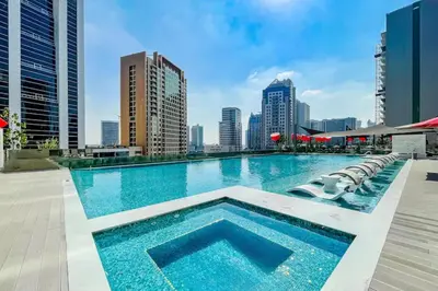 a large swimming pool on the roof of a building at MAG 318 Luxury Studio Resort Style Amenities in Dubai