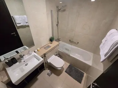 a bathroom with a sink and a toilet and a shower at Stunning 1-Bedroom Apartment in Botanica Tower in Dubai