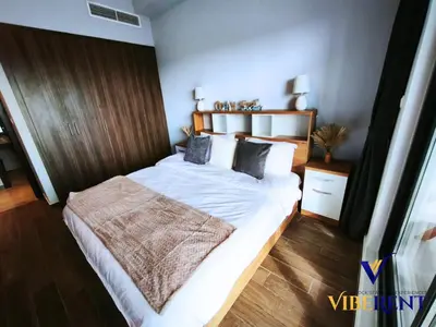 a bedroom with a large bed with white sheets and pillows at 2BHK near Expo, Al Maktoum Airport, Rooftop Pool in Dubai