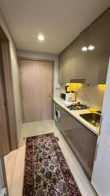 a kitchen with a rug in the middle of a kitchen at Luxure Studio with Pool View in Dubai
