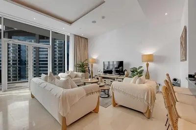 a living room with white furniture and a large window at Waves - Grand Palm Escape - Sea-View Massive 1BR Luxury in Dubai