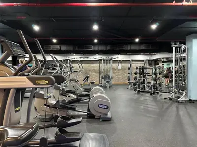 a gym with a bunch of cardio equipment in it at Waves - Grand Palm Escape - Sea-View Massive 1BR Luxury in Dubai