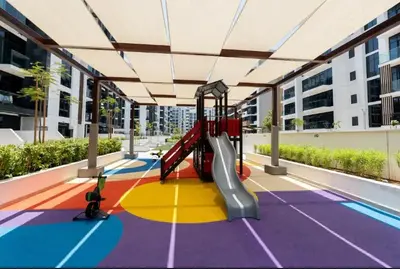 a playground with a slide in the middle of a building at Luxury Studio in the Heart of Meydan in Dubai