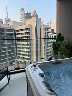 a bath tub sitting on top of a building at Stylish central apartment, own Jaccuzi, burj view in Dubai