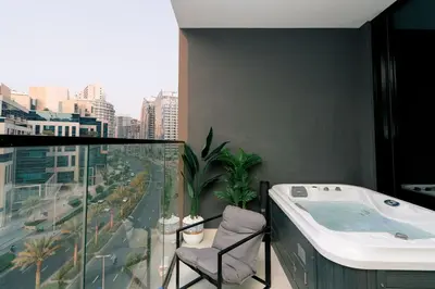 a bathroom with a bath tub and a view of a city at Stylish central apartment, own Jaccuzi, burj view in Dubai