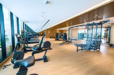 a gym with treadmills and exercise equipment in a building at Stylish central apartment, own Jaccuzi, burj view in Dubai