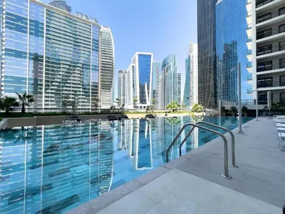 a swimming pool in a city with tall buildings at 4 Person - Resort Canal View - CBD Parking Pool in Dubai