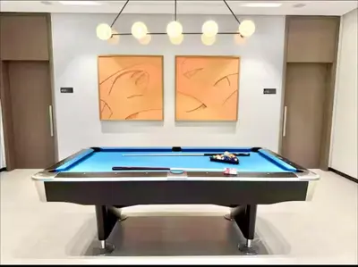 a pool table in a room with two paintings at Ultra-Luxury 2BR with Burj Khalifa view Downtown in Dubai