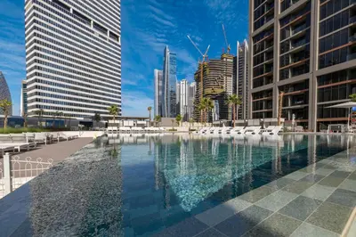 a large pool in a city with buildings at Luxury High-Floor Canal View near Burj Khalifa in Dubai