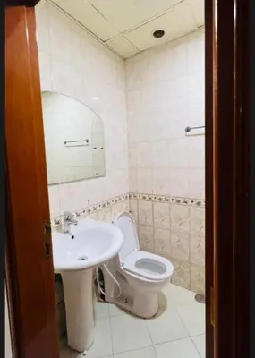 a bathroom with a sink and a toilet and a mirror at Prime Living Partition Room In Barsha Heights Tecom in Dubai