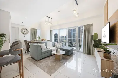 a living room with a couch and a table at Beautiful Marina Skyline Serenity Spacious n Bright in Dubai