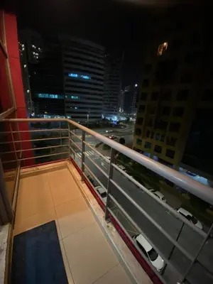 a view of a city at night from a balcony at Mystic Nook Partition Room In Barsha Heights Tecom in Dubai