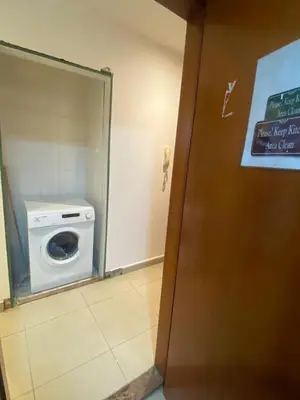 a bathroom with a washing machine in a stall at Mystic Nook Partition Room In Barsha Heights Tecom in Dubai