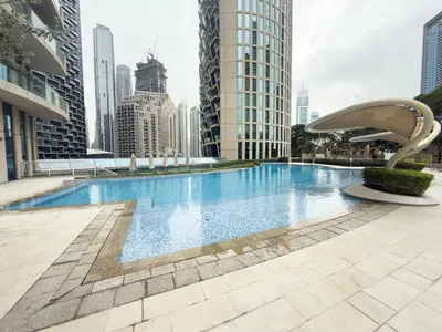 a swimming pool in a city with tall buildings at Premium 1BR in Downtown & Direct Access to Metro in Dubai