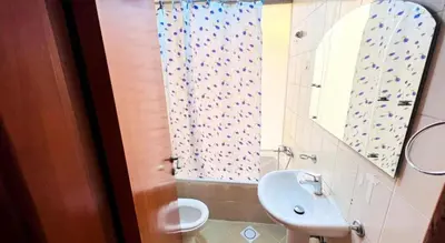 a bathroom with a sink and a toilet and a mirror at Skyline Stay Partition Room In Barsha Heights Tecom in Dubai