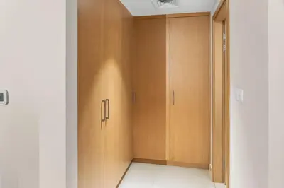 a corridor with wooden cabinets in a room at Luxury Apartment - Burj Khalifa, Creek - Best View in Dubai
