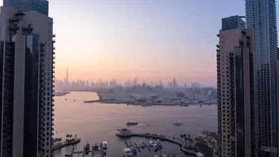a view of a river between two tall buildings at Luxury Apartment - Burj Khalifa, Creek - Best View in Dubai